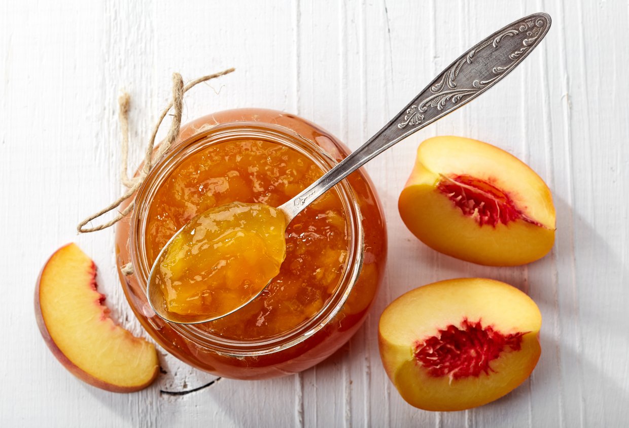 Jar,Of,Peach,Jam,On,White,Wooden,Background,From,Top
