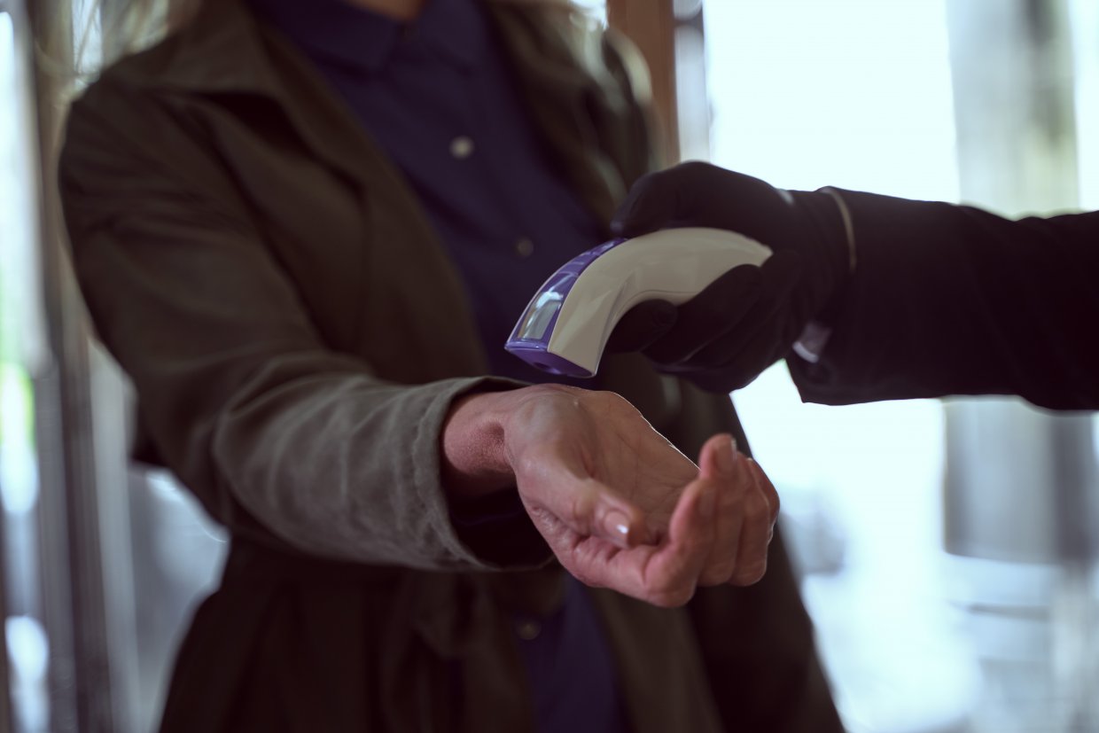 Well Dressed,Woman,Holding,Her,Wrist,Up,While,Extending,Her,Hand