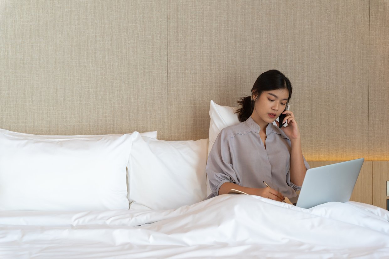 Young,Asian,Woman,Relaxing,In,The,Hotel,And,Working,With