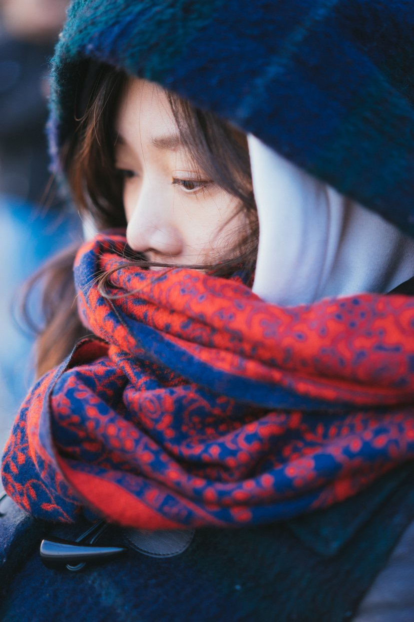 An,Asian,Lady,Wearing,A,Red,Scarf,In,A,Cold