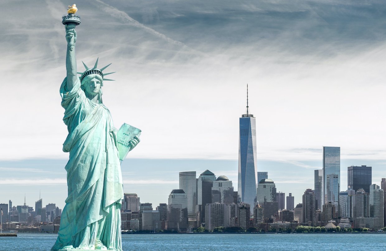 The,Statue,Of,Liberty,With,One,World,Trade,Center,Background,