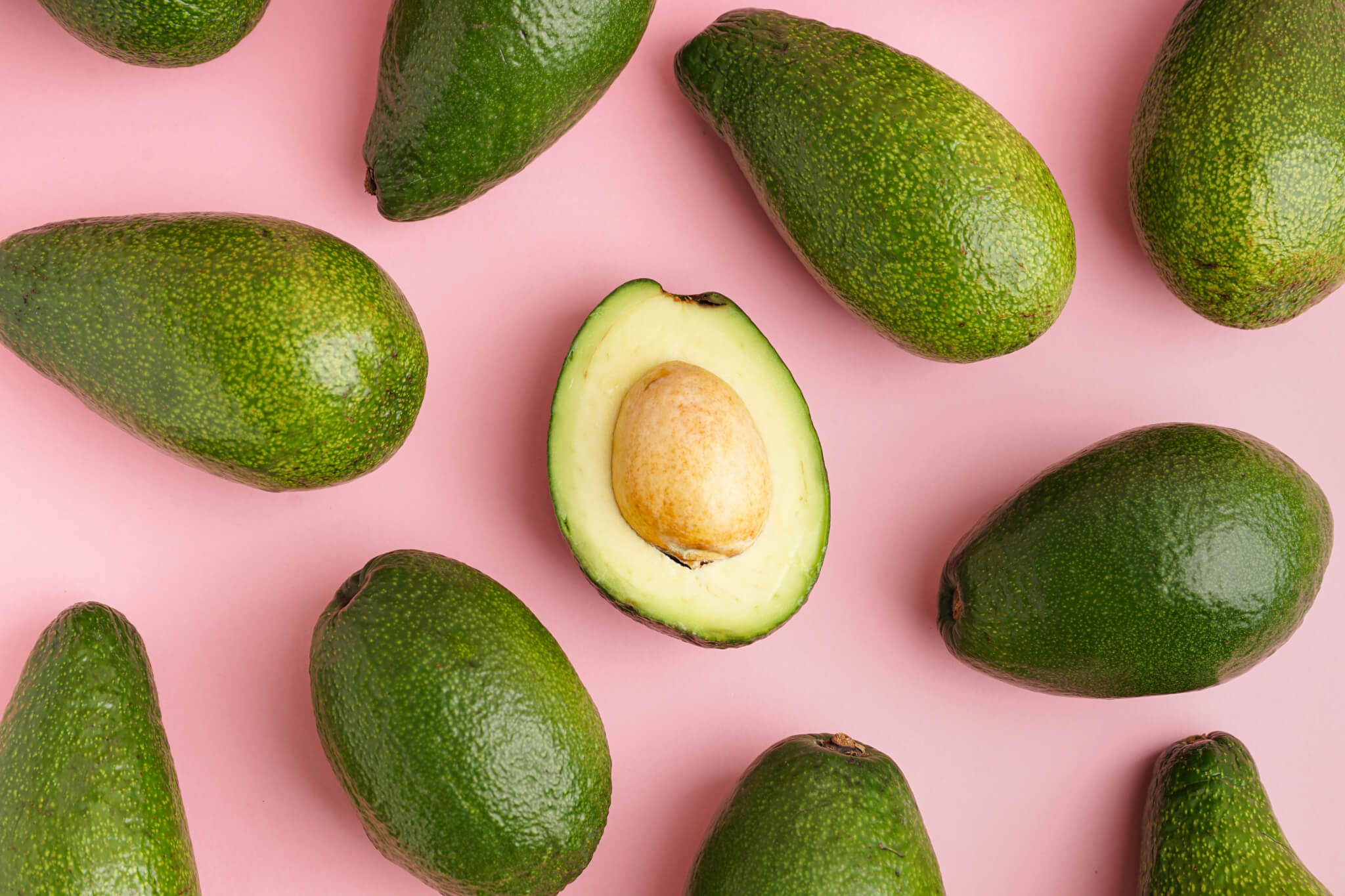 Fresh,Ripe,Avocados,On,Pink,Background